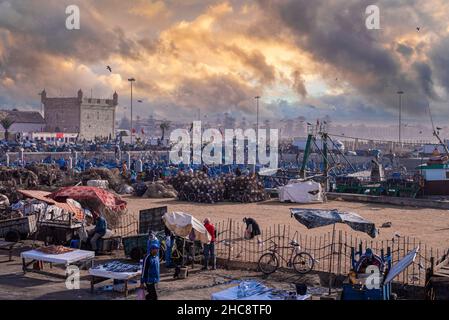 Local fish market in front of historic fortress at harbor against dramatic sky Stock Photo