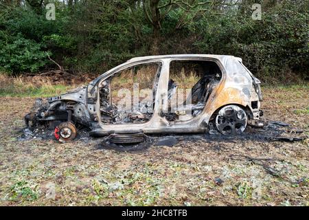 Burnt Out Volkswagen Golf GTi Car in Field Stock Photo