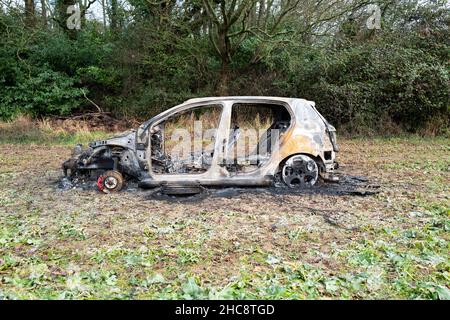 Burnt Out Volkswagen Golf GTi Car in Field Stock Photo