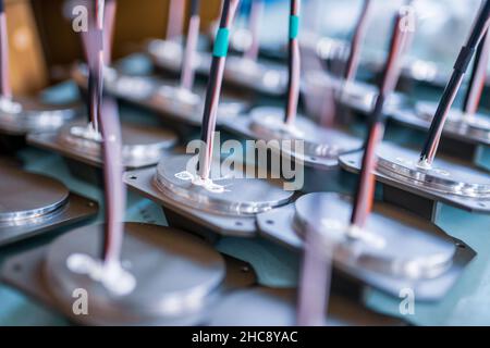 Details with cables for modern TFT monitors prepared on table in assembling workshop of production plant extreme close view Stock Photo