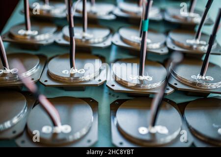 Pattern of details with cables for TFT monitors prepared on table in assembling workshop of production plant extreme upper close view Stock Photo