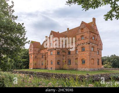 the famous red castle Borreby is a red brick-building surrounded by a moat in the southern Zealand, Denmark, August 10, 2021 Stock Photo