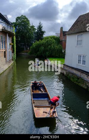 Cambridge, United Kingdom - August 1, 2021: Tourist punting on the river Cam, viewed from Magdalene bridge.