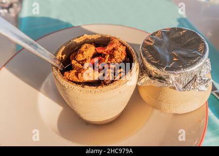 Testi kebab is an authentic Turkish delicious meat dish baked in a clay pot, served after breaking the jug. Stock Photo