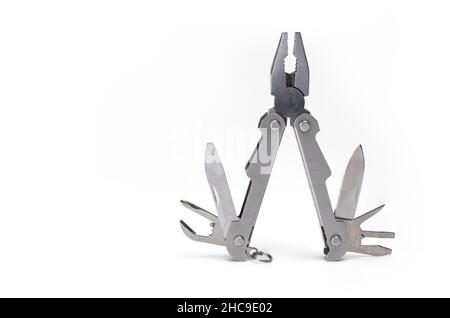 Close up of opened metal multitool with pliers knife screwdriver and can opener isolated on white background Stock Photo