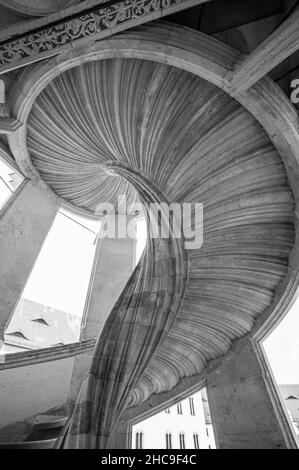 Grayscale, low angle shot of a spiral stairway Stock Photo