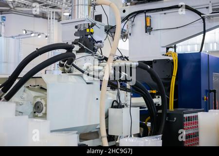 Part of automatic plastic injection molding machine during work Stock Photo