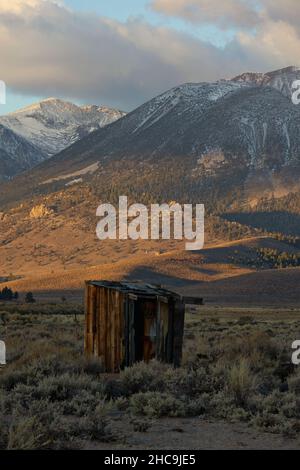 Old abandoned outhouse in front of sunrise on  the Sierra Nevadas Stock Photo