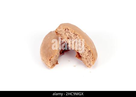 A closeup of small bread divided into two parts on a white background. Stock Photo