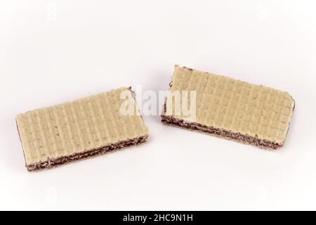 Split biscuit. Cracked waffle isolated on white background. Wafers with chocolate filling on a white background Stock Photo