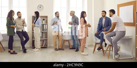 Groups of business people having informal discussions after work meeting in office Stock Photo