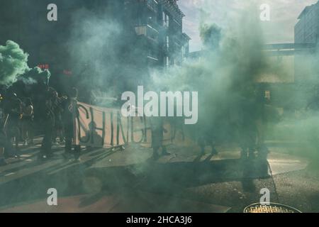 Seattle, USA. 25th Sep, 2021. Late in the day protestors setting off smoke grenades at the Chinga La Migra Anti-Ice march. Stock Photo