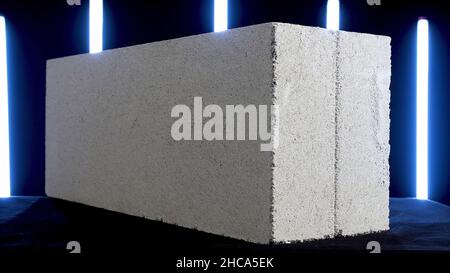 Demonstration of white concrete block on black background with sveral blue neon lamps. Close up of concrete slab, construction materials concept. Stock Photo