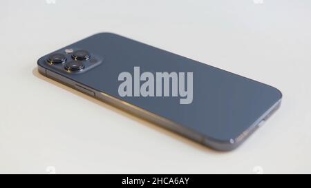 Shenzhen, China - 10.8.2020: Close up of a new iPhone 12 Pro Max isolated on white table background. New device of Pacific Blue color. Stock Photo