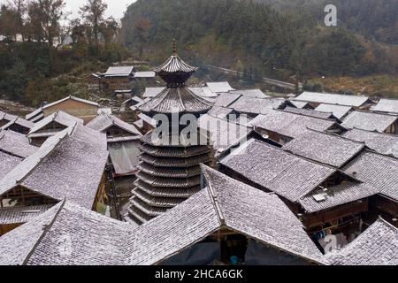 CONGJIANG, CHINA - DECEMBER 26, 2021 - An aerial photo taken on Dec. 26, 2021 shows snow scenery in a traditional Chinese village in Congjiang County, Stock Photo