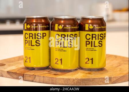 Calgary, Alberta - December 26, 2021: Cans of Crisp Pils brewed bu crafter brewer, Jasper Brewing Co. Stock Photo