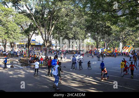 Nairobi, Kenya. 25th Dec, 2021. Children skating on Aga Khan walk, on Christmas Day. For many years, Kenyans living in Nairobi and its environs have spent Christmas Day at the Uhuru and Central parks. However, that is not the case this year, as the two parks remain closed for renovations. This did not stop them from enjoying the day in small spaces that were available. (Photo by Boniface Muthoni/SOPA Images/Sipa USA) Credit: Sipa USA/Alamy Live News Stock Photo