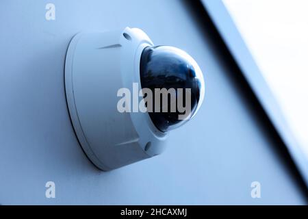 surveillance camera mounted on a wall outdoors Stock Photo