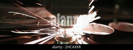 Laser cutting of metal sheet with sparks closeup Stock Photo