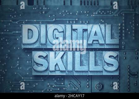 digital skills phrase made from metallic letterpress blocks on the pc board background Stock Photo