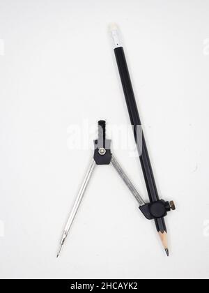 a stainless steel compass and a pencil used in geometry for drawing circles isolated in a white background Stock Photo