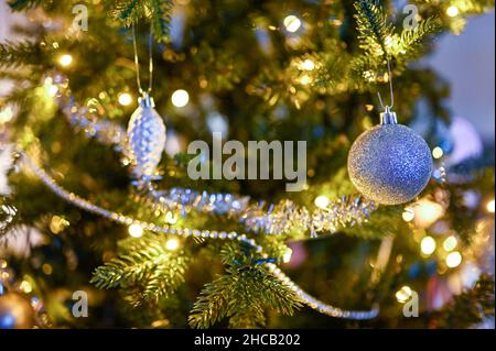 close up of decorations in Christmas tree indoors Stock Photo