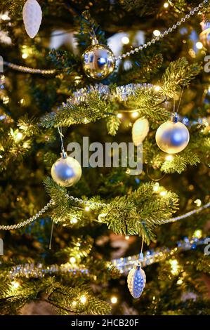 close up of decorations in Christmas tree indoors Stock Photo