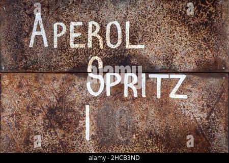 Aperol Spritz price. White text on a rusty surface. Stock Photo