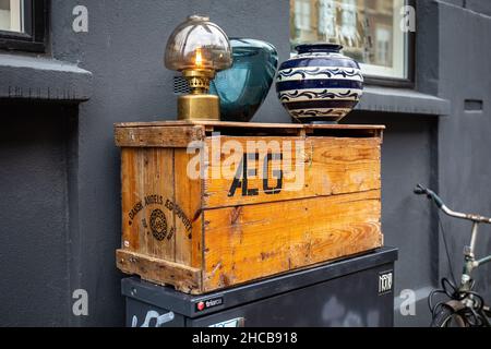 Oil lamp and vases on a wooden duck egg box outside a second-hand store in Copenhagen, Denmark Stock Photo