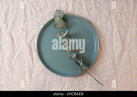 Green colored circle shaped ceramic plate on isolated background, food mockup Stock Photo