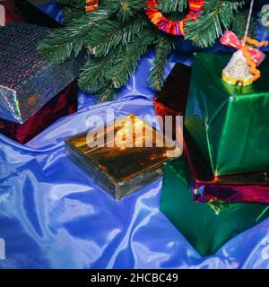 Christmas and New Year gifts in beautiful boxes under the Christmas tree Stock Photo