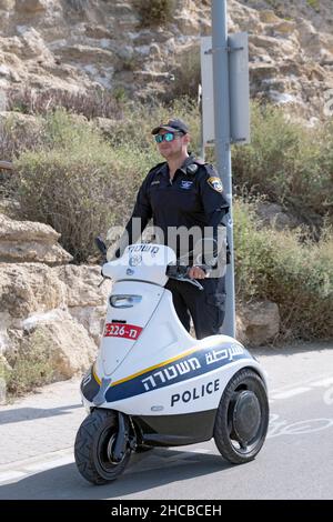 A Tel Aviv policeman on a modern 3-wheeled Segway vehicle patrolling the Jim Spitz bike path near the Mediterranean Sea in Israel. Stock Photo