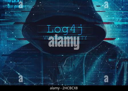 Hooded computer hacker in cybersecurity vulnerability Log4J concept with digital glitch effect Stock Photo