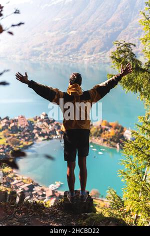 Man with arm around showing lake to friend at Interlaken, Switzerland Stock Photo