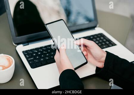 Businesswoman using smart phone at sidewalk cafe Stock Photo