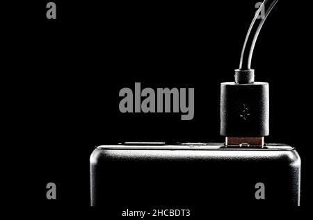 Charger, battery for charging the phone and other gadgets on a dark background. Power banks Stock Photo