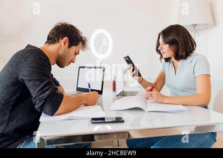 Young male and female freelancer working together on table at home Stock Photo