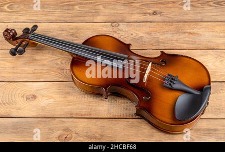 Top view of a violin lying on a wooden table. Copy space. Stock Photo