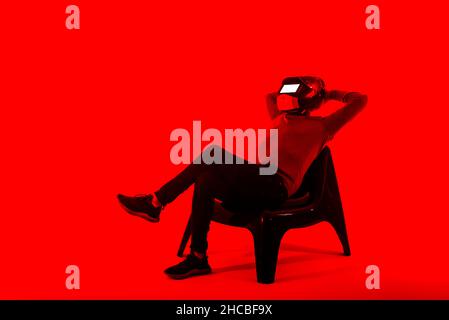 Man wearing helmet using digital tablet on red background Stock Photo