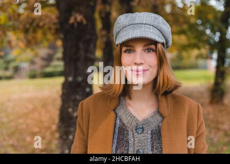 Beautiful young woman smiling in public park Stock Photo