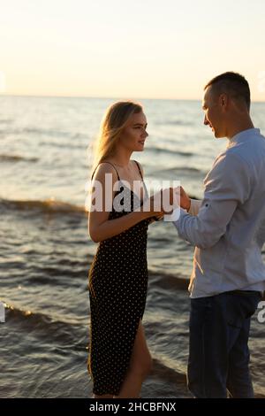 Young couple holding hands at beach Stock Photo