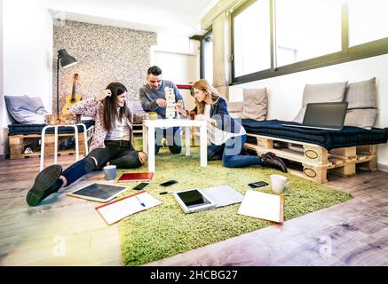 Young people employee workers having break in start up office - Human resources business concept with creative entrepreneurs on fun working game Stock Photo