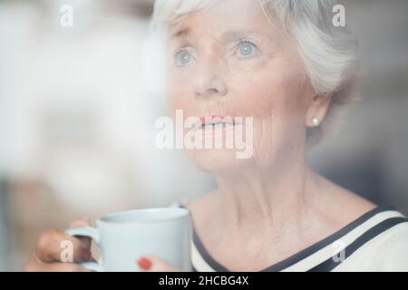 Senior woman using virtual reality simulator at home Stock Photo