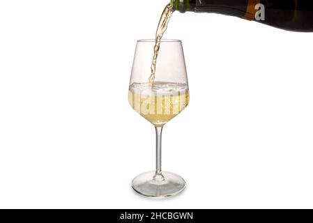 Champagne or sparkling wine pouring into glass from bottle with splashing,  isolated on white, copy space Stock Photo