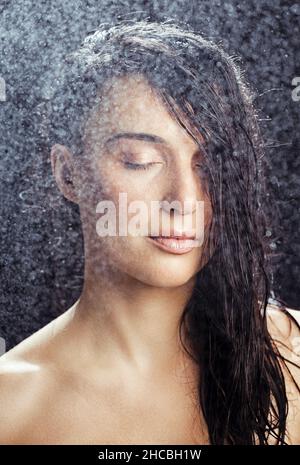 Water spraying on woman with eyes closed Stock Photo