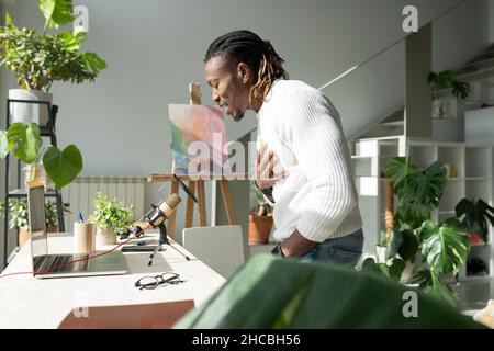 Vlogger podcasting in living room Stock Photo