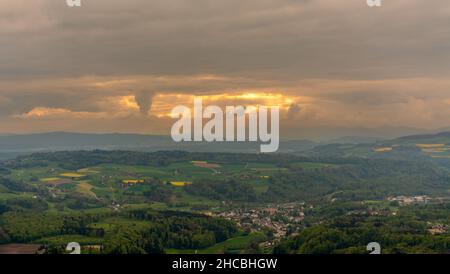 Beautiful view of the sun rays bursting through the clouds from the observation deck on Mount Uetliberg in Zurich, Switzerland. Dramatic natural light Stock Photo