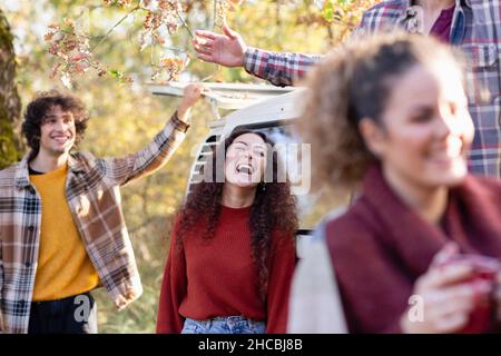 Friends having fun in autumn forest on weekend Stock Photo
