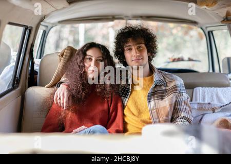 Young couple sitting in campervan Stock Photo