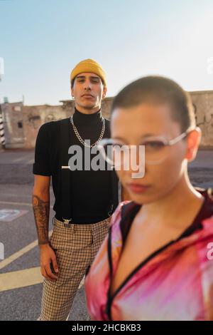 Young man standing with friend on road Stock Photo